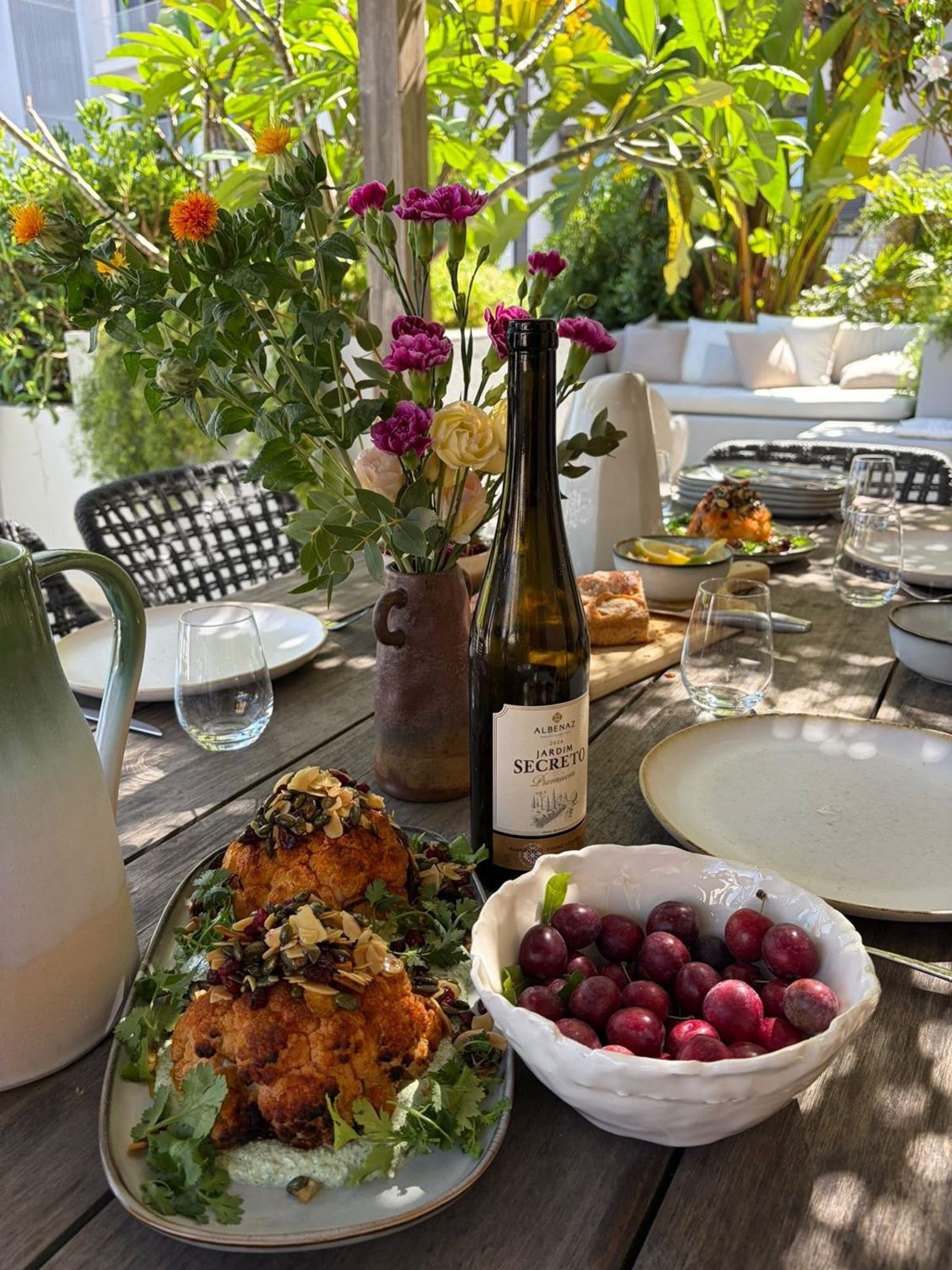 A La Bisoni table — flowers, wine, harissa cauliflower and summer cherries