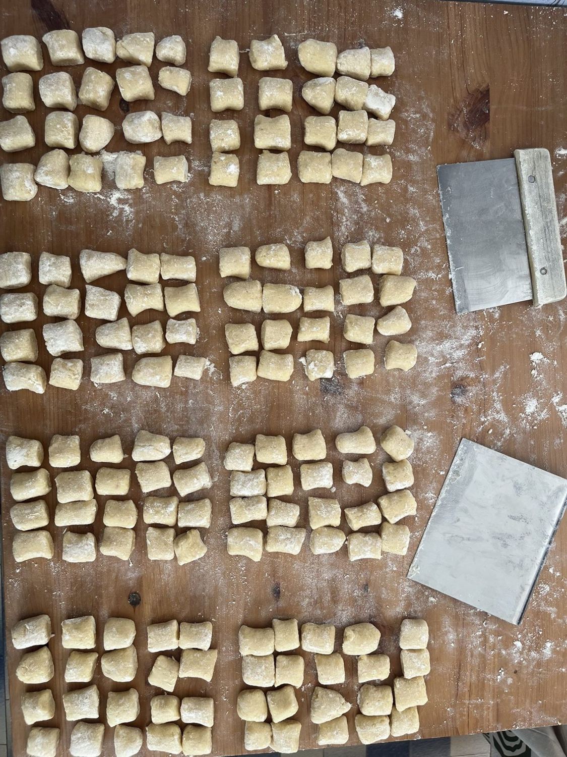 Rows of freshly cut gnocchi on a floured bench