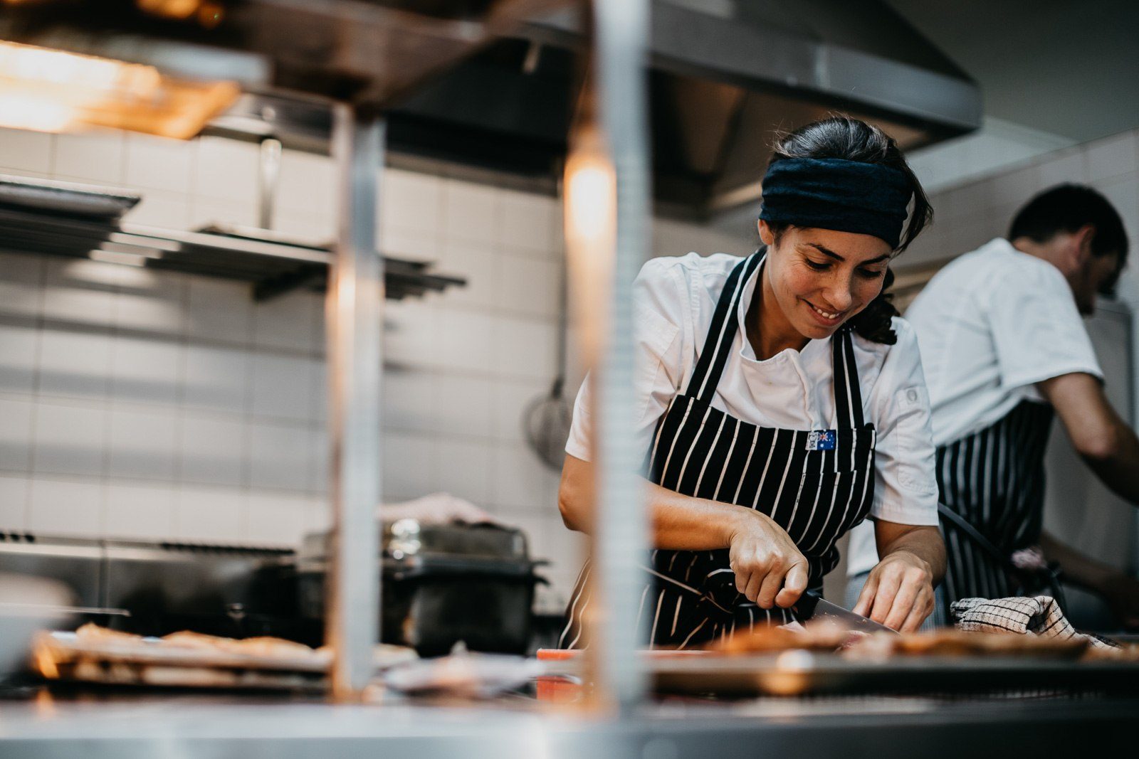 Lara at work in the kitchen, knife in hand