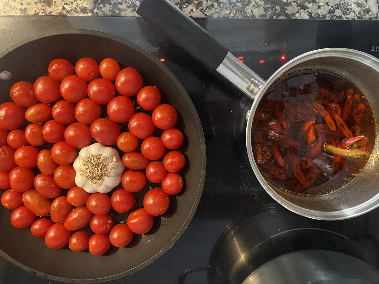 Market cherry tomatoes and garlic in the pan